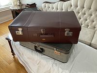 Brown and gray suitcases stacked showing overall form and color