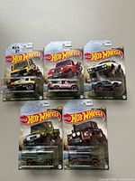 Group shot of all five sealed Hot Wheels Mud-Runners vehicles on card.