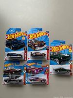 All five Hot Wheels Mustang cars laid out in packaging