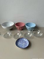 All eight items: three ceramic bowls, four glass bowls, one patterned plate