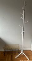 Coat rack next to stacked yellow and black shoe racks