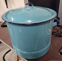 Full view of blue enamel stockpot with lid on