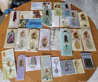 Overview of all prayer cards, rosaries, keychains and bookmark arranged on table