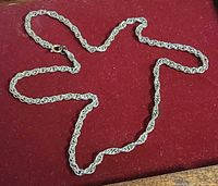 Full view of rope chain necklace laid flat