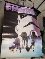 Poster showing Stormtrooper helmet and AT-AT walkers with explosions