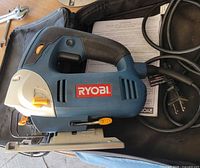 Ryobi JS451L corded jig saw with power cord inside soft carrying case, manual visible