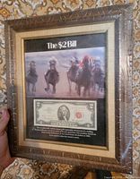 Front view of framed display showing horse racing photo and $2 bill