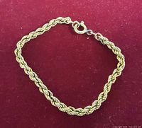 Full view of rope chain bracelet on red background