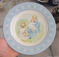 Front of plate showing illustration, rim design and gold trim