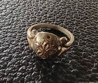 Top view of sterling silver ring with floral design