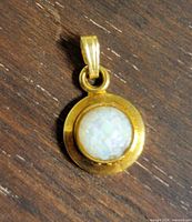 Front view of gold-filled pendant showing gemstone cabochon and bail
