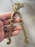 Front view of brass rooster head nutcracker, full length visible