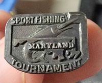 Front of sterling Maryland Sportfishing Tournament pin showing marlin graphic and text