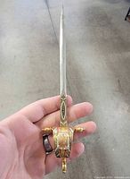 Full view of sword letter opener in hand