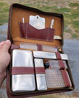 Open leather vanity case showing all grooming components strapped in place
