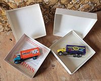 Both trucks in open white boxes with inserts