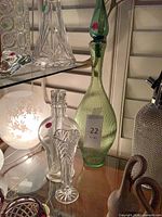 Group shot showing green decanter, clear decanter and bud vase