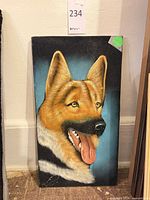 Full view of German Shepherd painting leaning against wall