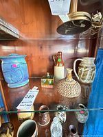 Shelf view showing all five vases grouped together