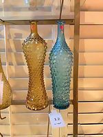 Front view of both hobnail glass vases hanging side by side
