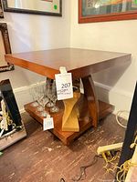 Full view of square wood veneer side table with lower shelf and curved legs