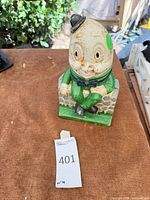 front view of cast iron Humpty Dumpty bank on wall