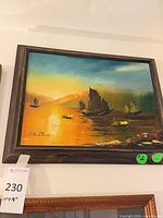 Full view of framed seascape painting on wall