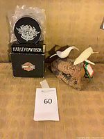 Harley-Davidson coaster set boxed beside John Perry bird sculpture on base