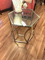 Full view of hexagonal glass top side table showing frame design and condition