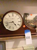 Howard Miller mantel clock and one painting visible