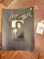 Front cover showing Janet Jackson portrait and silver autograph with lot tag visible
