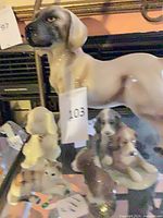 Group view showing large hound and smaller puppy figurines
