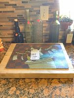 Wood cutting board with decorative glass bottles behind