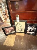 Three framed items: Ocean's Eleven lobby card, J. Robert Watt portrait, Breakfast at Tiffany's photo