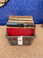 Front view of gray plastic crate filled with LP records