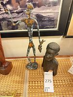 Both sculptures side by side on surface