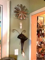 Clock and vase displayed on wall for scale and context