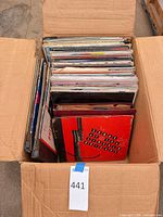 Cardboard box filled with upright 12-inch records