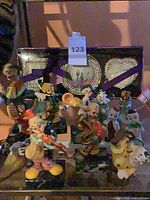 group shot showing all clown figurines and rhinestone picture frame