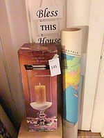 Full lot showing boxed hurricane candle holder, rolled map tube, Bless This House sign