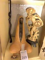 Full lot showing staff, ceramic hooded form, resin statue, toy car
