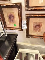 Both framed portrait prints hanging side by side
