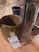 Group shot shows glass St-Germain bottle, brown terracotta vase, upper portion of blue ceramic vase
