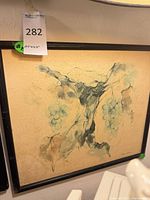 Full view of framed artwork showing grape and vine composition in black bamboo frame