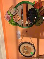 Mirror with tulip stained glass border and round framed print hanging below