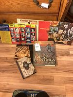 Group shot: four LPs standing, three books stacked