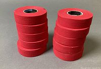 Two stacks totaling ten red cloth tape rolls