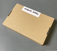 Sealed cardboard box labelled "MESSAGE BOARD"