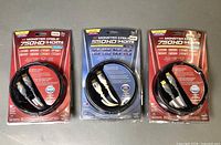 Three sealed Monster Cable HDMI cables in packaging, two red 750HD 2 m and one blue 550HD 1 m