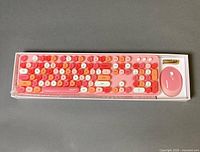 Keyboard and mouse in retail tray showing multicolour keys